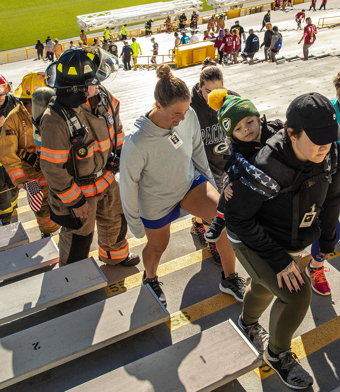 A crowd of people climbing stadium bleachers