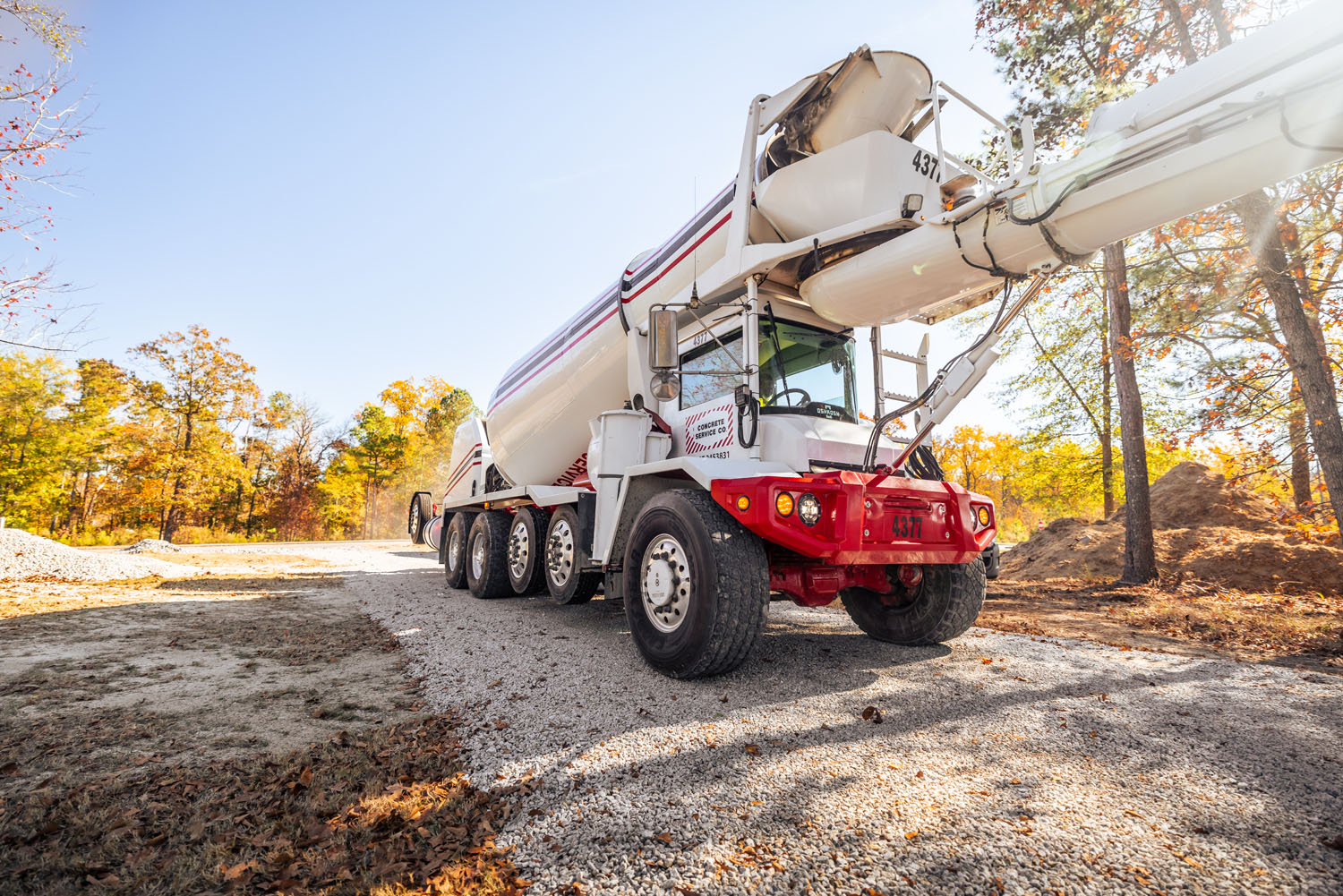 White S-Series front discharge mixer outside on a sunny day driving on gravel