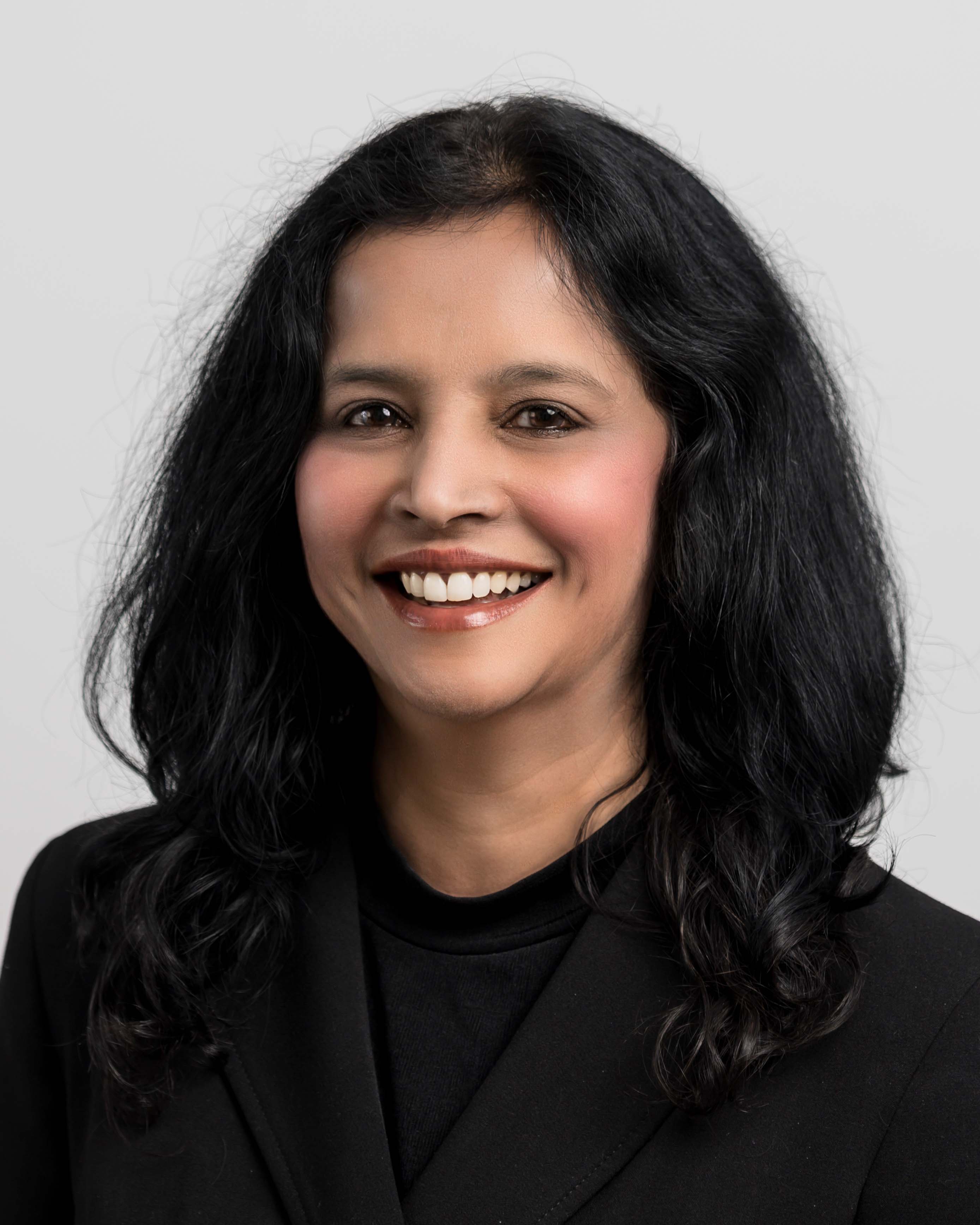 'Female Jay Iyengar wearing a black top and smiling '