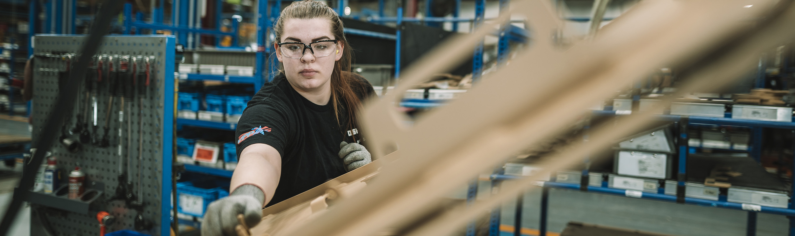 Female student assembling truck pieces